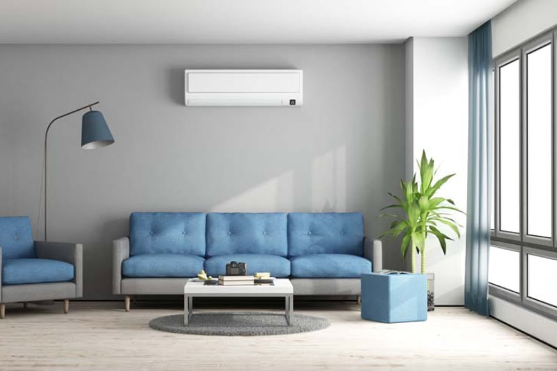 Ductless Mini Splits for Comfortable and Healthy Living. Blue and gray modern living room with sofa, armchair and air conditioner.