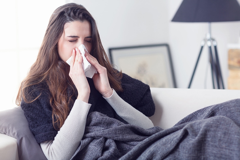 Blog Title: What Does Indoor Air Quality Have to Do With Allergies? Photo: Woman sneezing