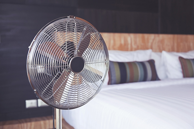 Old electric fan near the bed in the room, Improve Your Home’s Indoor Air Quality